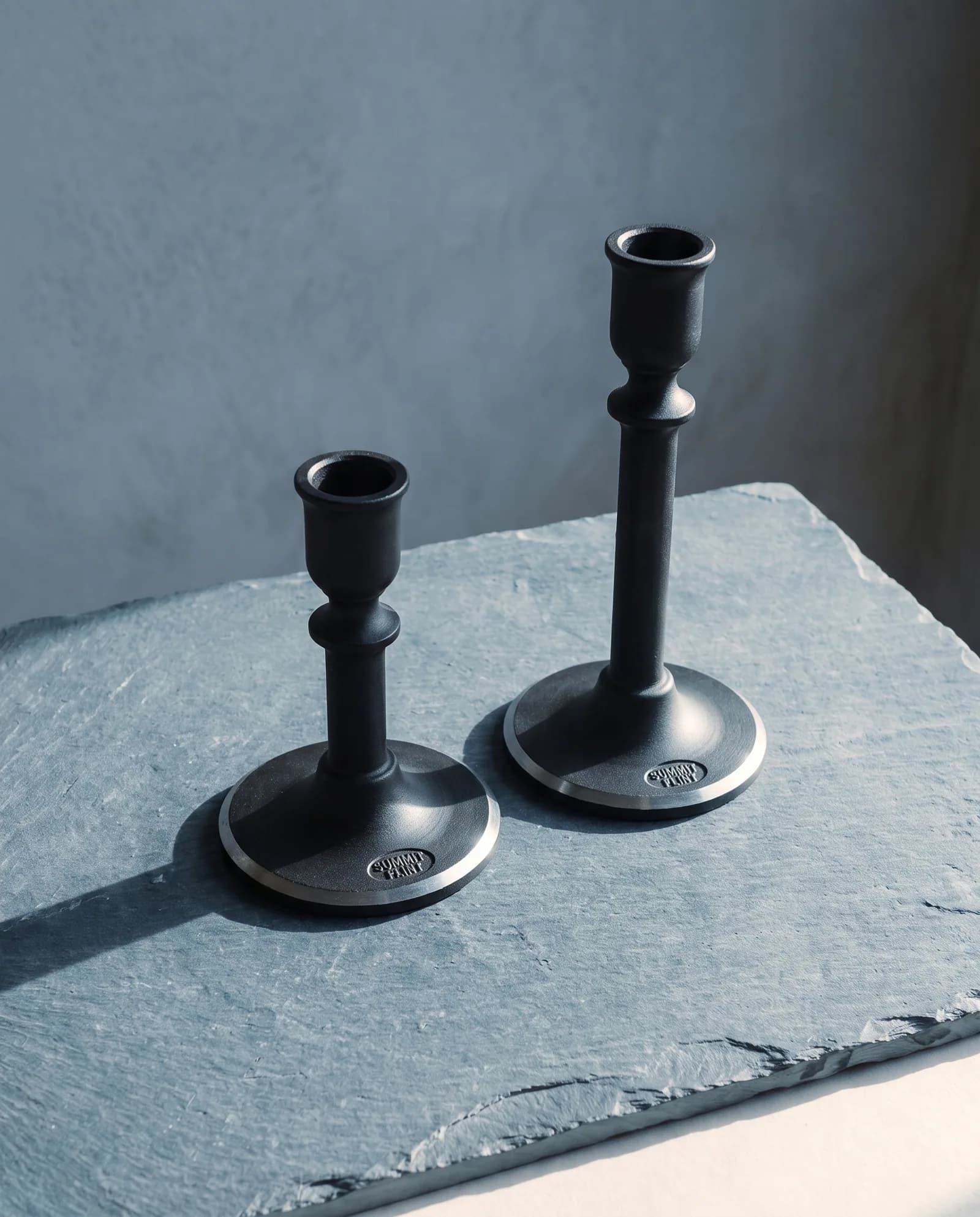 Candle Holders, Pair — Blackened steel, weighted base, taper fit.