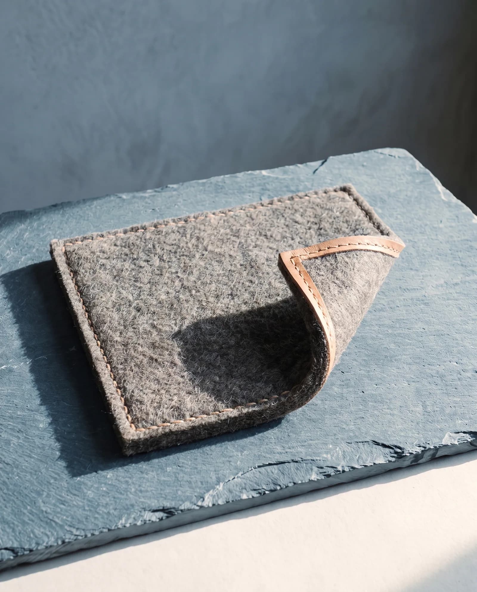 Wool Felt Hearth Mat — 12 mm pressed felt, undyed, bound edge.