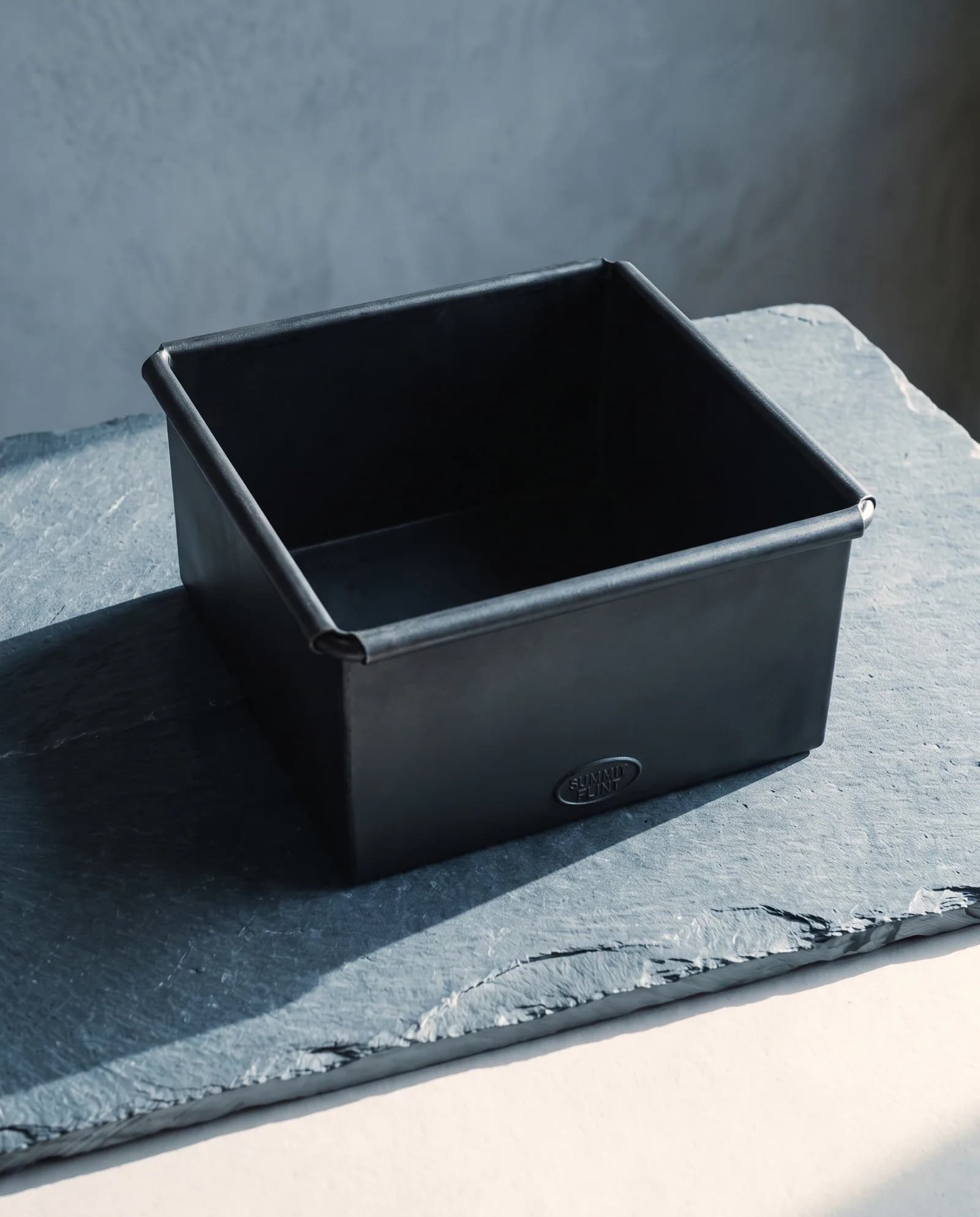 Kindling Box — Blackened steel, open top, hearth-height.