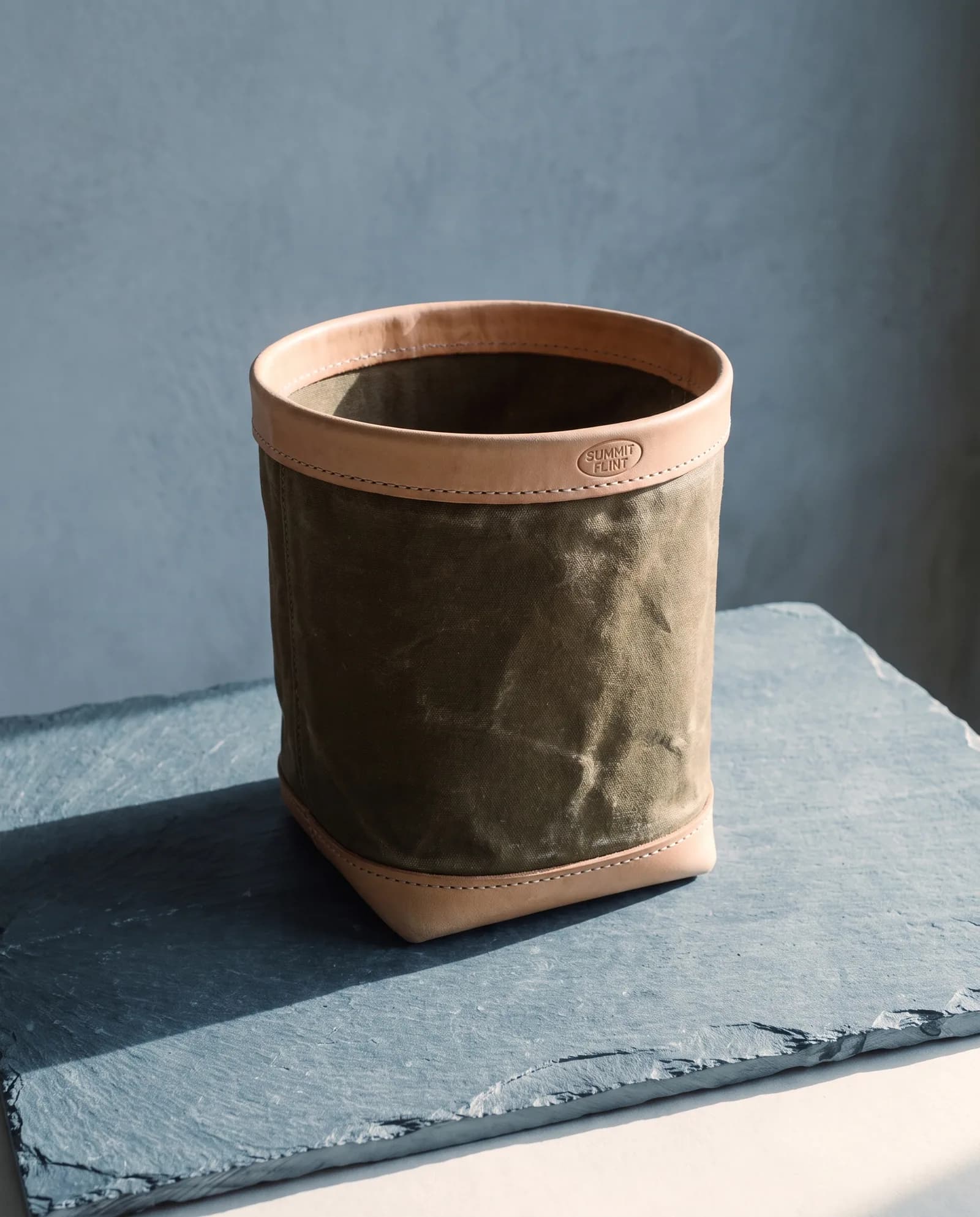 Kindling Tote — Waxed canvas bucket, leather-bound rim.