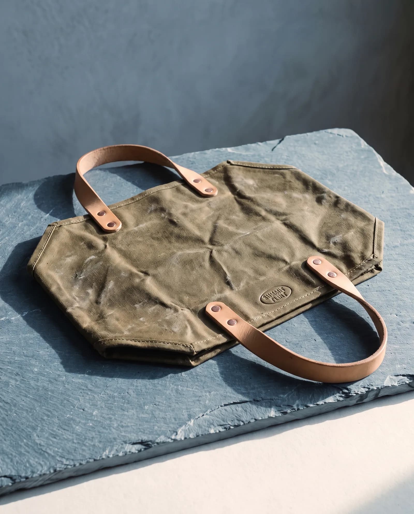 Log Carrier — 18 oz waxed canvas, bridle leather handles.