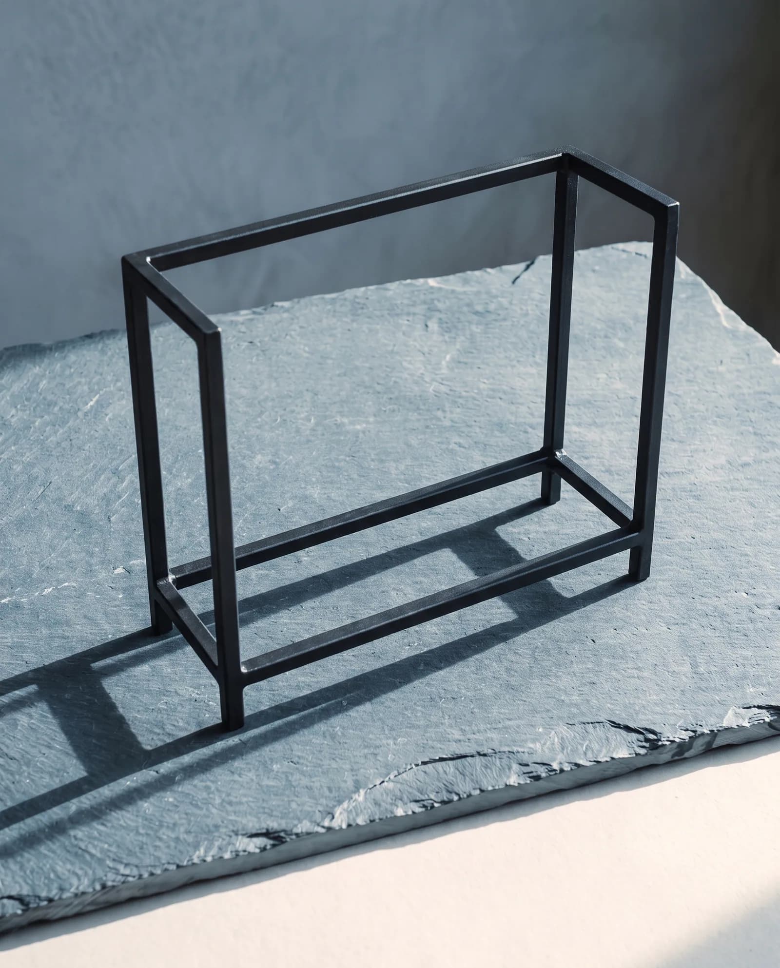 Log Rack — Blackened steel, 36 inches, welded.