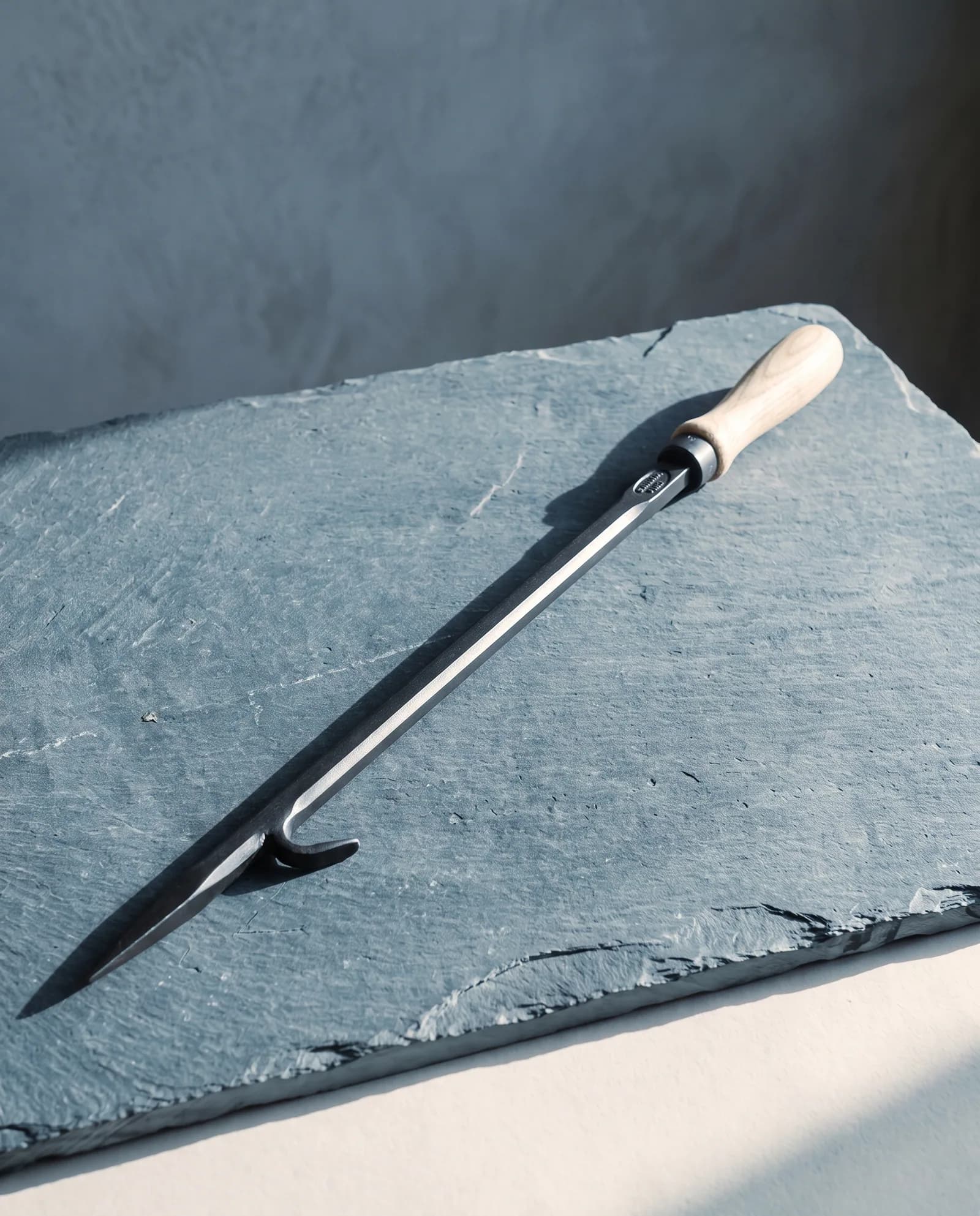 The Long Poker — 32-inch blackened steel, pinned ash handle.