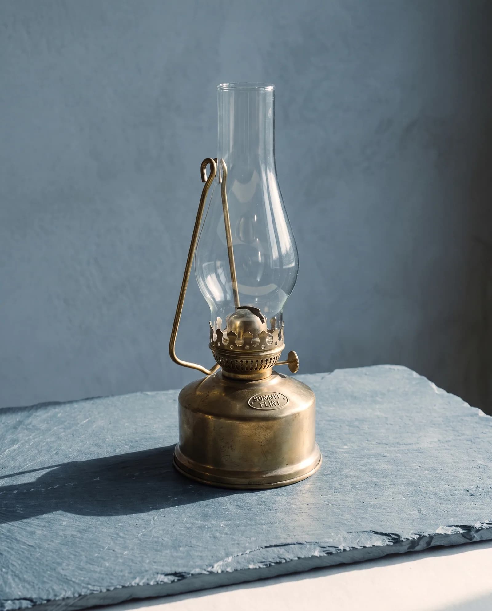 Brass Storm Lantern — Unlacquered brass, flat wick, replaceable glass.